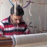 A Kashmiri artisan weaving a Pashmina shawl on his handloom. (Photo by Athar Parvaiz)