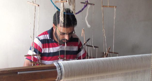 A Kashmiri artisan weaving a Pashmina shawl on his handloom. (Photo by Athar Parvaiz)
