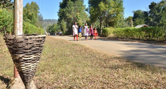 The paths of Shikdamakha village are dotted with bamboo baskets to collect waste. (Photo by Abdul Gani)