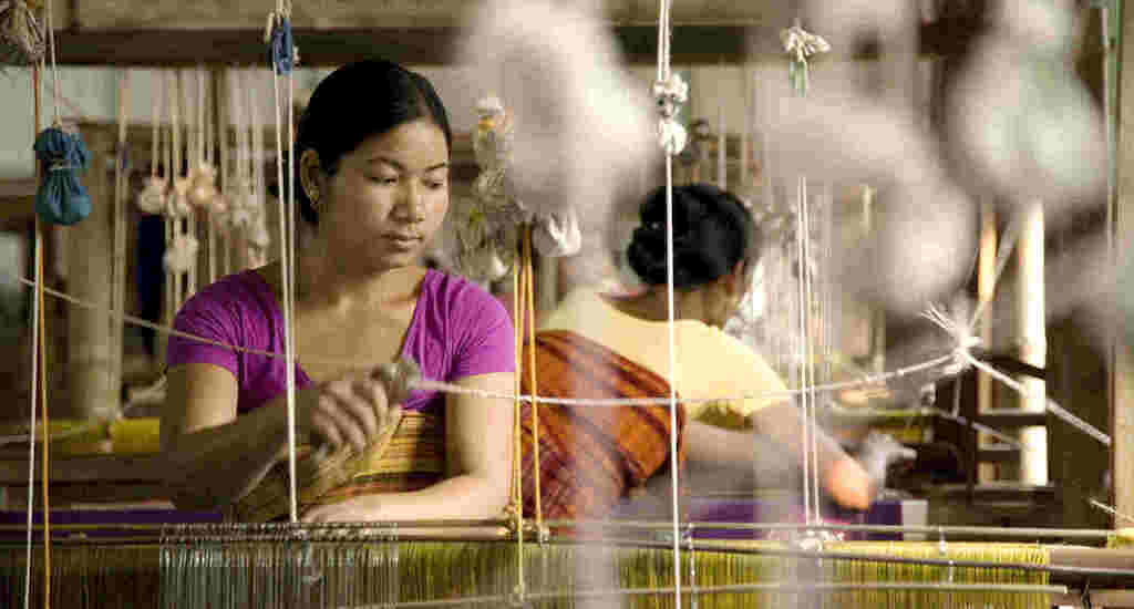 A Bodo woman working at a traditional handloom in Rowmari village. (Photo by Action for Northeast Trust)