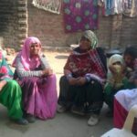 A group of village women in Nuh discusses the merits of digitizing the targeted public distribution system. (Photo by Debika Goswami)