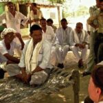 NGO executives attending a village meeting. (Photo by Austin Yoder)