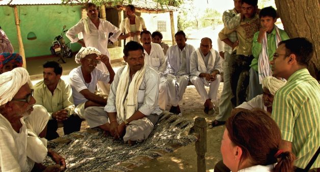 NGO executives attending a village meeting. (Photo by Austin Yoder)