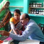 A doctor attends to patients at Gaon Dawakhana, the community-owned village clinic that runs on family subscriptions. (Photo by Lokpriya Janhit Sewa Sansthan)