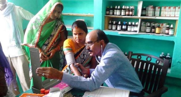 A doctor attends to patients at Gaon Dawakhana, the community-owned village clinic that runs on family subscriptions. (Photo by Lokpriya Janhit Sewa Sansthan)