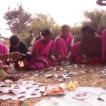 Women of self-help group in Ghagra village of Gumla district in Jharkhand distributing kitchen garden seeds among themselves. (Photo by Soumi Kundu)