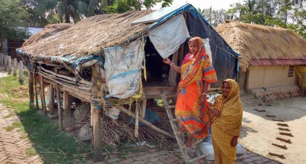 Women who remain on the island after the men migrate take shelter in a stilt house during floods. (Photo by Sayanti Sengupta)