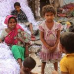 In a roadside ghetto, Akila Bibi and others after a day’s hard work, separating white paper shreds from the colored ones for recycling. Earning Rs 3 a kg, they manage 30 kg to 50 kg a day. (Photo by Manipadma Jena)