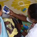 A lactating mother is being checked for blood pressure at the daycare center in Godiguda village in Araku Valley (Photo by Basudev Mahapatra)