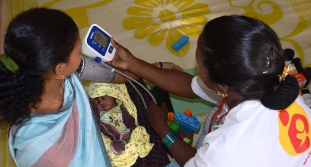 A lactating mother is being checked for blood pressure at the daycare center in Godiguda village in Araku Valley (Photo by Basudev Mahapatra)