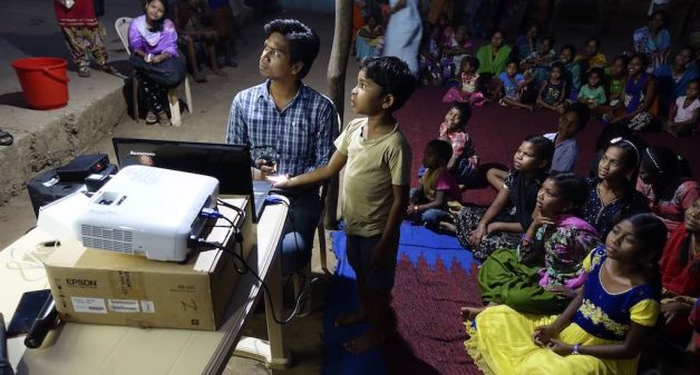 Villagers learnt about hygiene from coordinator Gouri Shankar after seeing invisible grime through a microscope (Photo by Rakhi Ghosh)