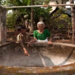 Madhavi of Chakkamkandam village has seen the pristine backwaters turn into a cesspool, contaminating even their open wells (Photo by Arun P.J.)