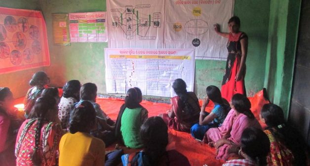 A poshan sakhi explains the importance of women, especially expectant and lactating mothers, eating nutritious food (Photo by Rakhi Ghosh)