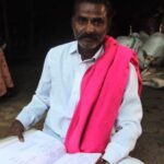 Lakshman Helavar, a traditional chronicler of family histories, with his carefully preserved genealogical records (Photo by Amoolya Rajappa)