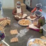 Tribal women packing millet biscuits for children of government schools at the community owned Neelamma Thalli bakery (Photo by C. Shambu Prasad)