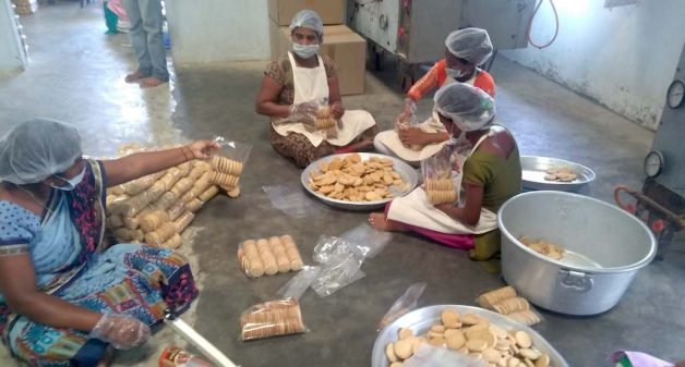 Tribal women packing millet biscuits for children of government schools at the community owned Neelamma Thalli bakery (Photo by C. Shambu Prasad)