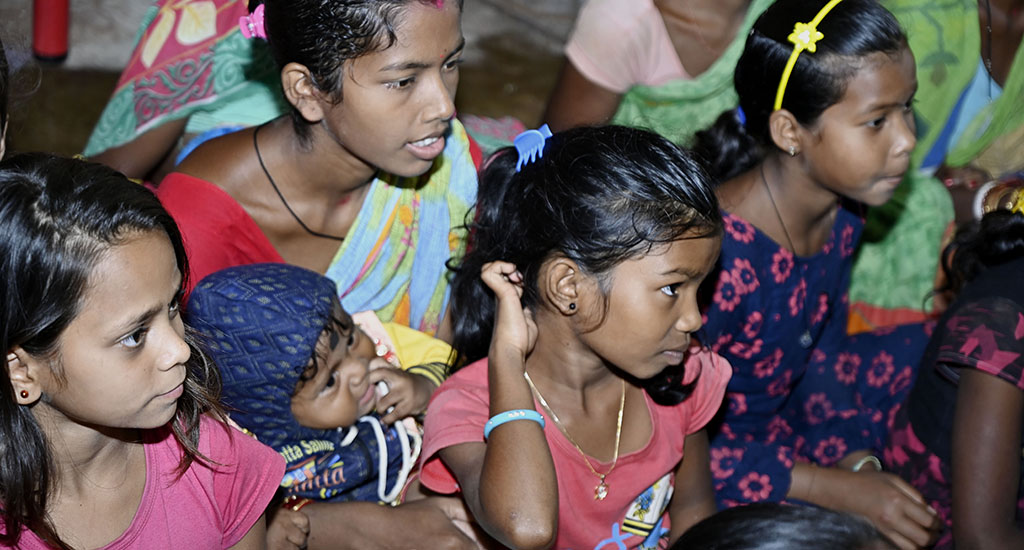 Children and women attending an awareness meeting on hot iron branding