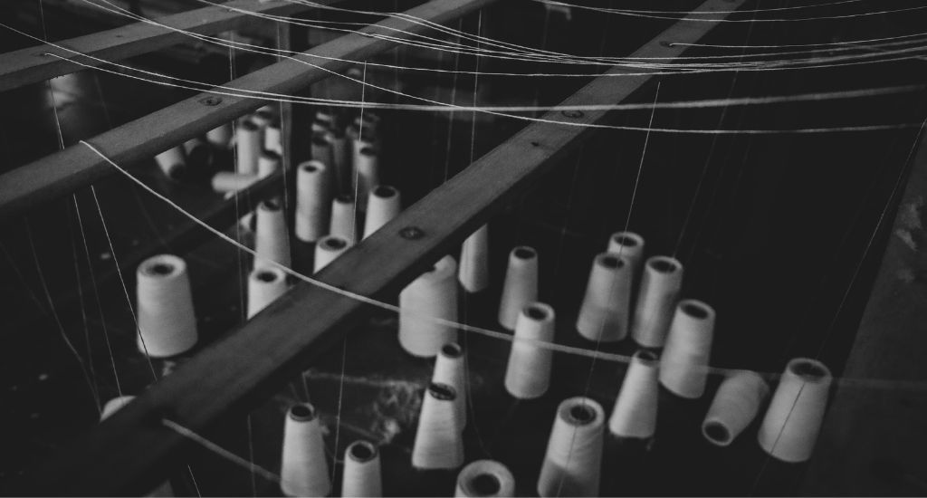 The lead photo at the top of this page shows threads of handloom (Photo by  Divyanshi Verma,Unsplash.)