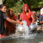 The women are happy that they do not have to walk miles every day to bring water