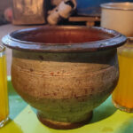 the apricot drink, stored in an earthen pot and served in glasses
