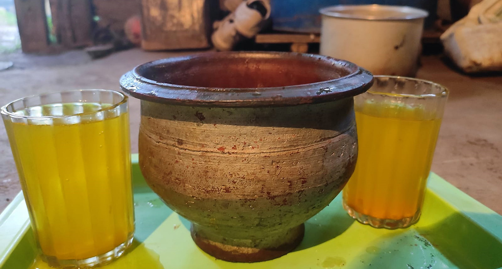 the apricot drink, stored in an earthen pot and served in glasses